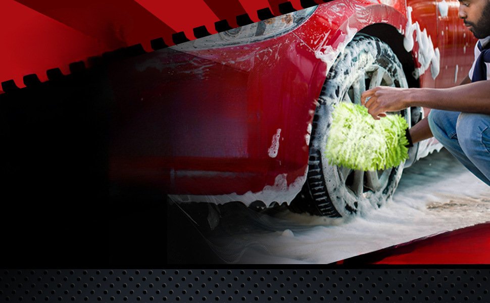 Hand wearing green chenille car wash mitt soaping up vehicle