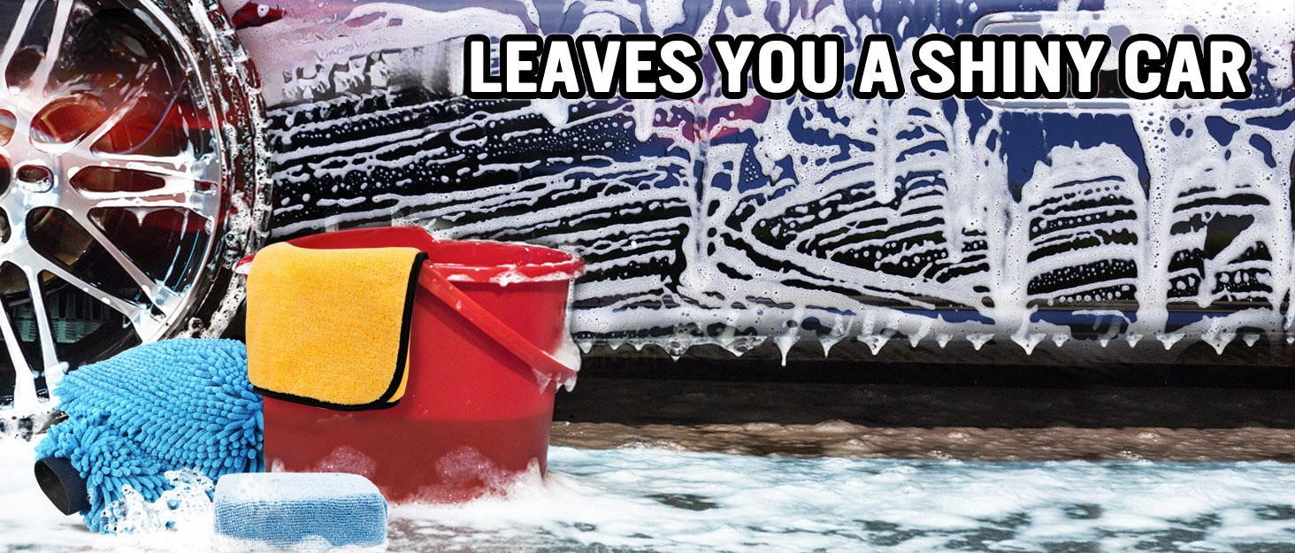 Hand wearing green chenille car wash mitt soaping up vehicle